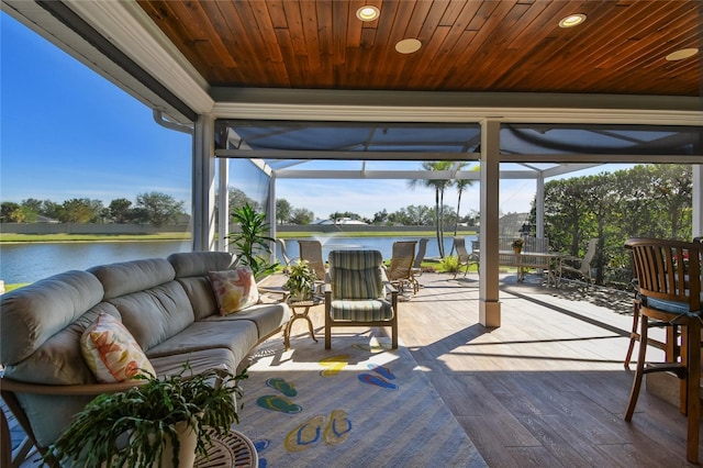 deck with outdoor lounge area, a water view, and a lanai