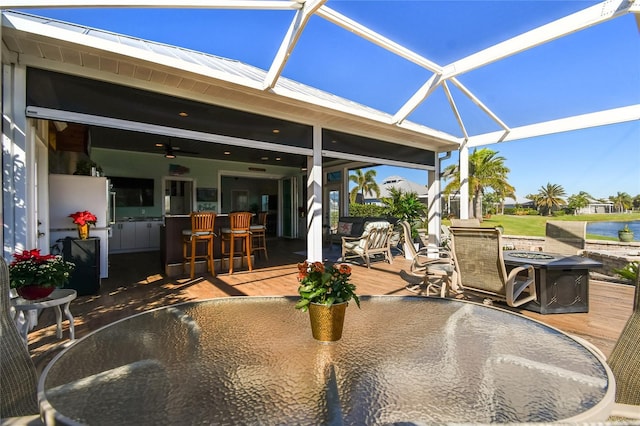 view of patio featuring a bar and a lanai