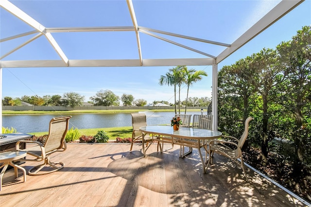 view of patio featuring a water view and glass enclosure