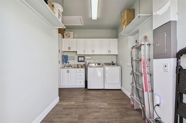 clothes washing area with cabinets, dark hardwood / wood-style floors, and independent washer and dryer