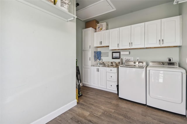 washroom with cabinets, dark hardwood / wood-style flooring, separate washer and dryer, and sink