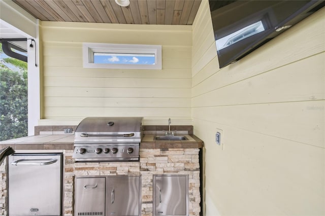 view of patio with a grill, area for grilling, and sink