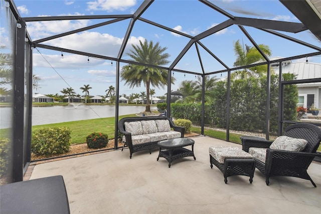 view of patio featuring a lanai, outdoor lounge area, and a water view