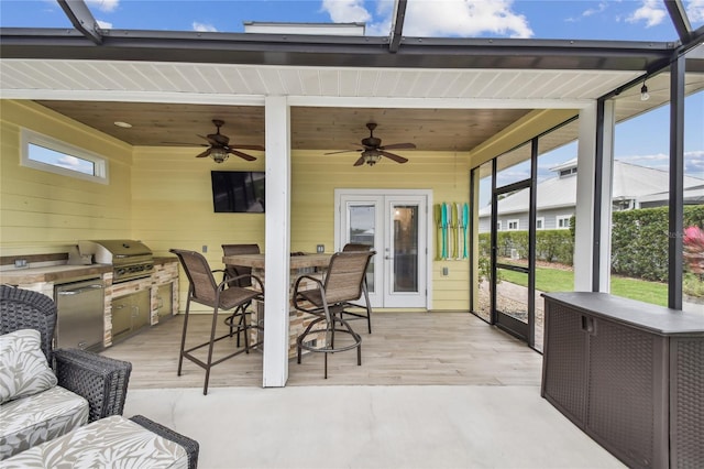 sunroom / solarium with french doors, ceiling fan, and wooden ceiling