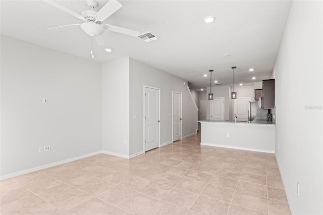 unfurnished living room featuring ceiling fan and light tile patterned floors