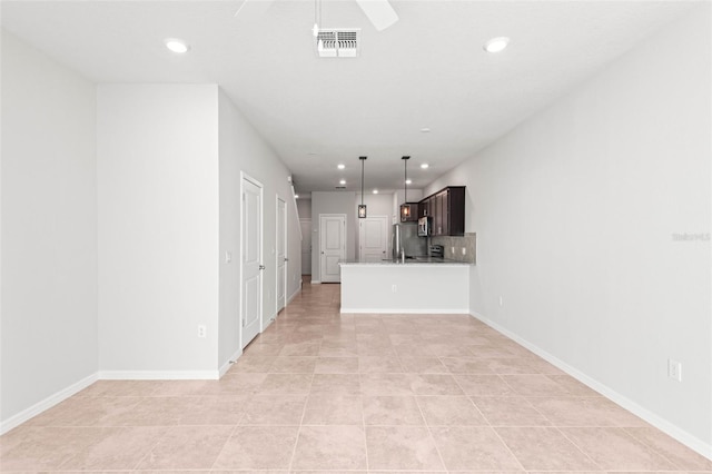 unfurnished living room with light tile patterned floors and ceiling fan