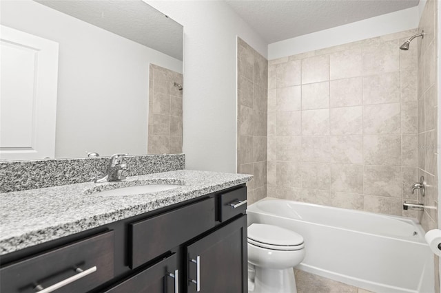 full bathroom with vanity, a textured ceiling, toilet, and tiled shower / bath