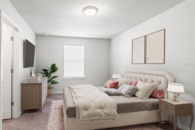 bedroom featuring carpet flooring and a textured ceiling