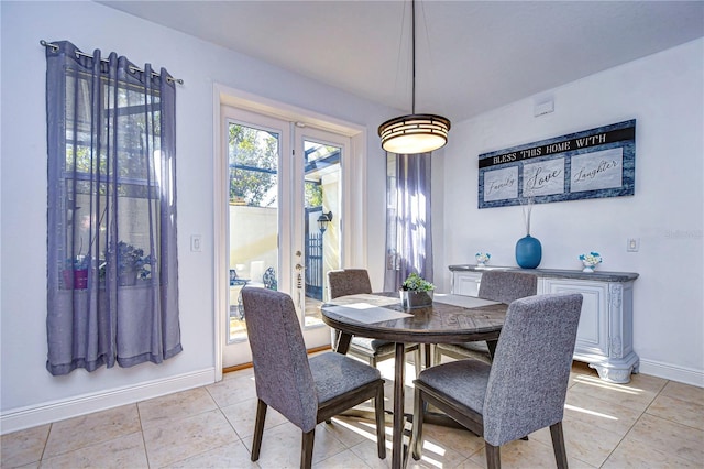 dining space featuring light tile patterned flooring