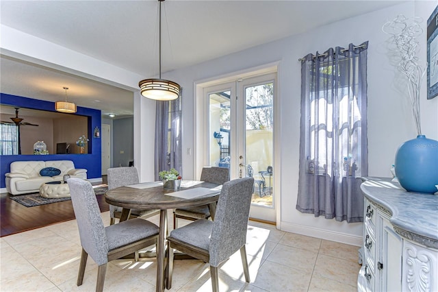 dining area with light hardwood / wood-style floors and ceiling fan