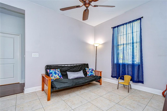 living area with ceiling fan and light tile patterned floors