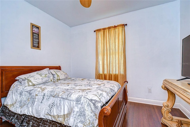 bedroom with dark hardwood / wood-style flooring