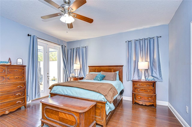 bedroom featuring access to outside, ceiling fan, dark wood-type flooring, and a textured ceiling