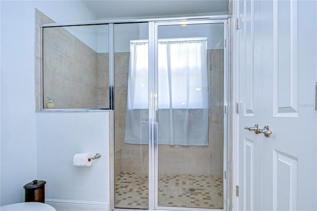 bathroom with a shower with door