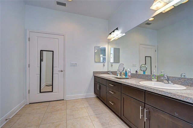 bathroom featuring tile patterned flooring and vanity