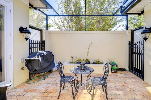 view of patio / terrace featuring area for grilling and a lanai