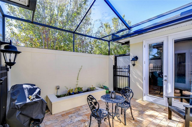 view of patio / terrace featuring area for grilling and glass enclosure