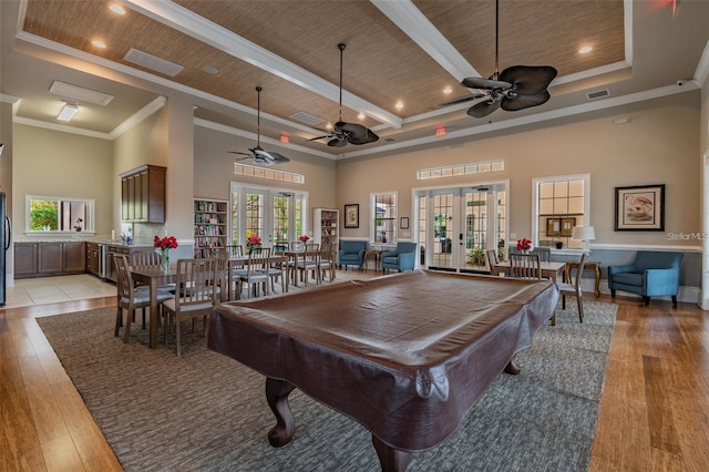 recreation room with french doors, ornamental molding, a high ceiling, light hardwood / wood-style floors, and pool table