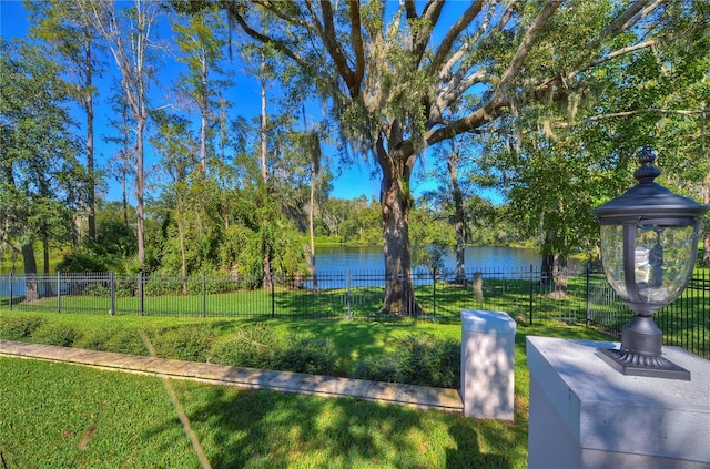 surrounding community featuring a water view and a lawn