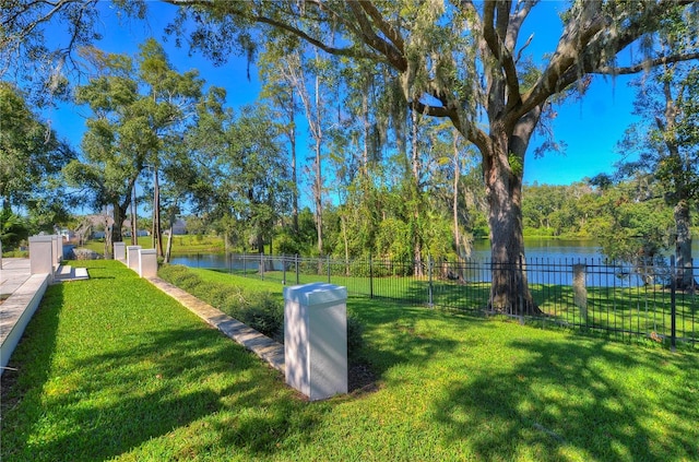 view of community featuring a yard and a water view