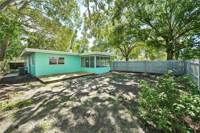 rear view of house featuring a patio and central AC unit