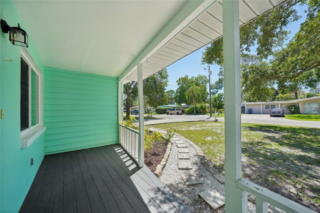 wooden terrace featuring covered porch