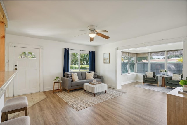 living room featuring light wood-type flooring and ceiling fan