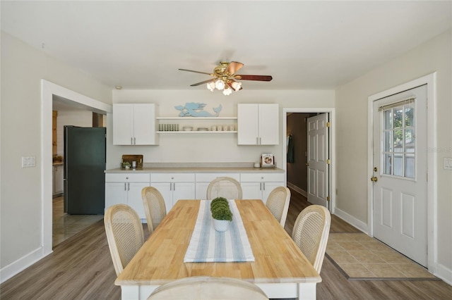 dining area with ceiling fan and light hardwood / wood-style floors