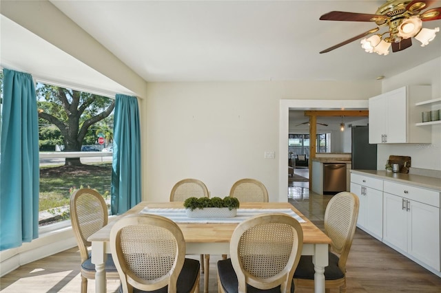 dining area with ceiling fan and wood-type flooring