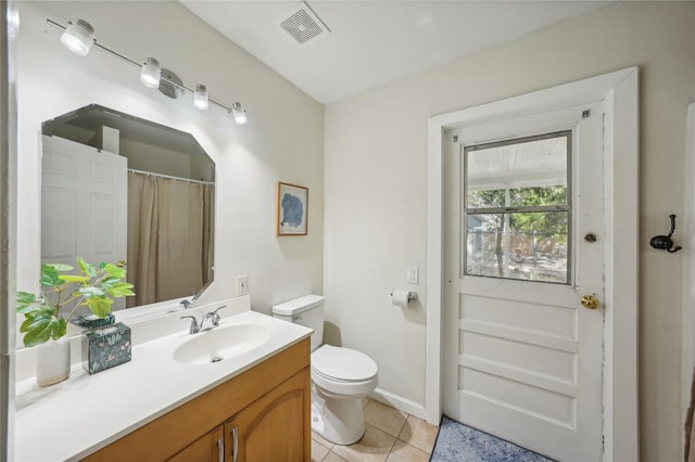 bathroom with tile patterned floors, vanity, and toilet