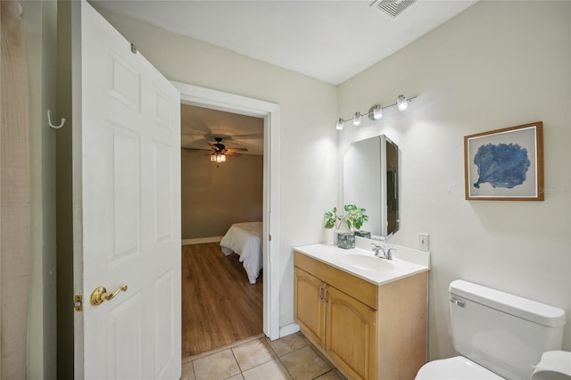 bathroom featuring tile patterned flooring, vanity, toilet, and ceiling fan