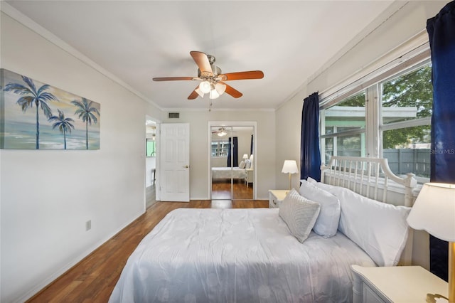 bedroom featuring ceiling fan, wood-type flooring, and ornamental molding