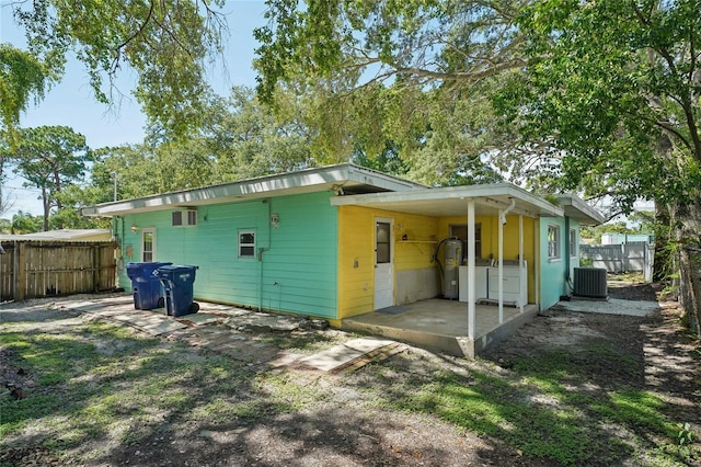 back of property with central AC