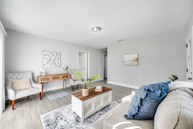 sitting room with hardwood / wood-style flooring