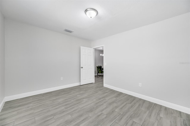 spare room with light hardwood / wood-style flooring