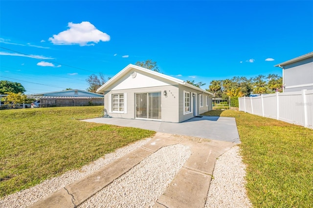 back of property featuring a yard and a patio