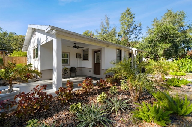 back of house with ceiling fan