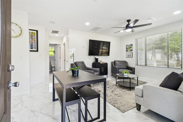 living room featuring ceiling fan and plenty of natural light