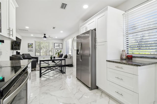 kitchen with white cabinetry, dark stone countertops, ceiling fan, and appliances with stainless steel finishes