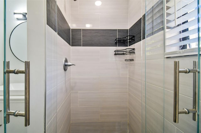 bathroom with a shower with shower door