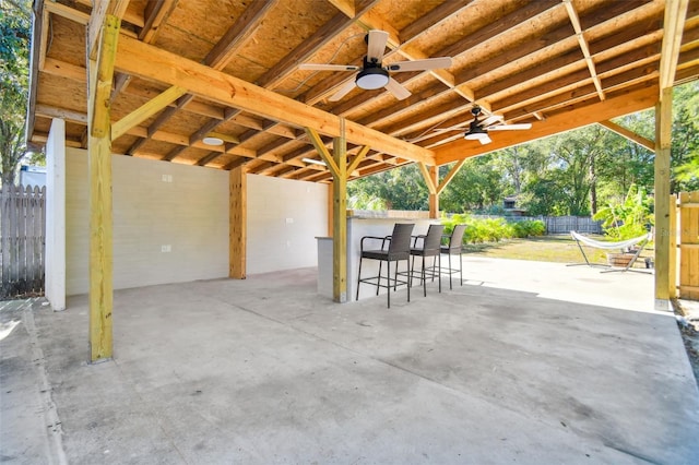 view of patio / terrace with ceiling fan and an outdoor bar