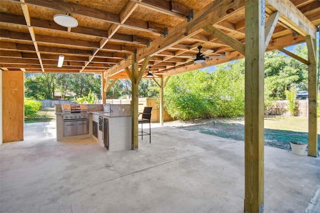 view of patio with area for grilling, sink, and ceiling fan