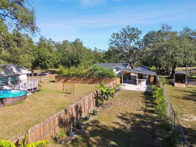 view of yard featuring a fenced in pool and a patio area