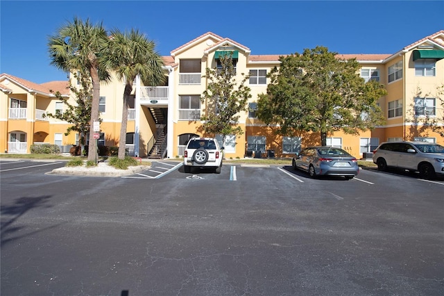 view of building exterior featuring uncovered parking