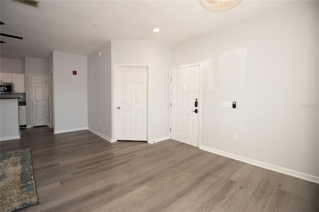 interior space with wood finished floors and baseboards