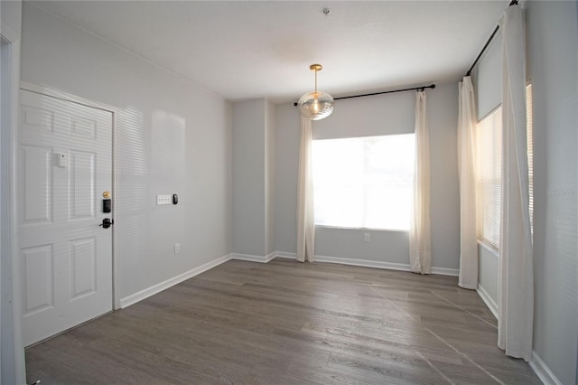 interior space with baseboards and wood finished floors