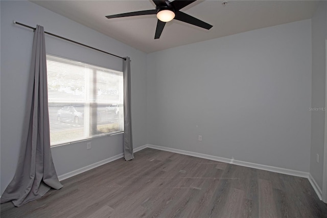 unfurnished room featuring ceiling fan, baseboards, and wood finished floors