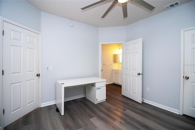 office area with dark wood-style flooring, visible vents, ceiling fan, and baseboards