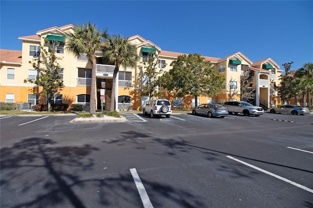 view of building exterior with uncovered parking