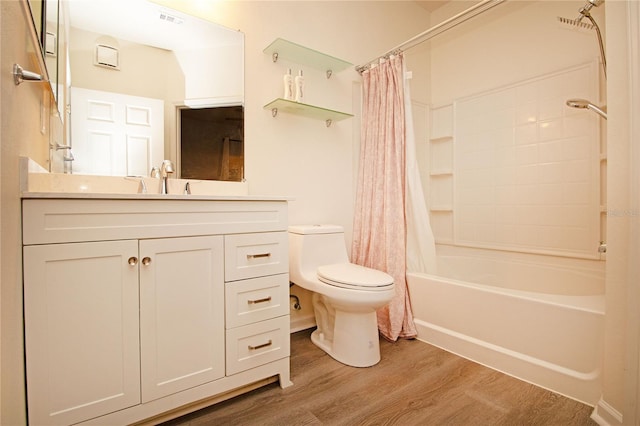 bathroom featuring toilet, shower / tub combo, wood finished floors, vanity, and visible vents